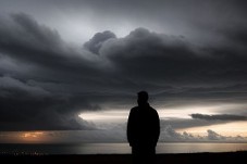 man standing on the seashore